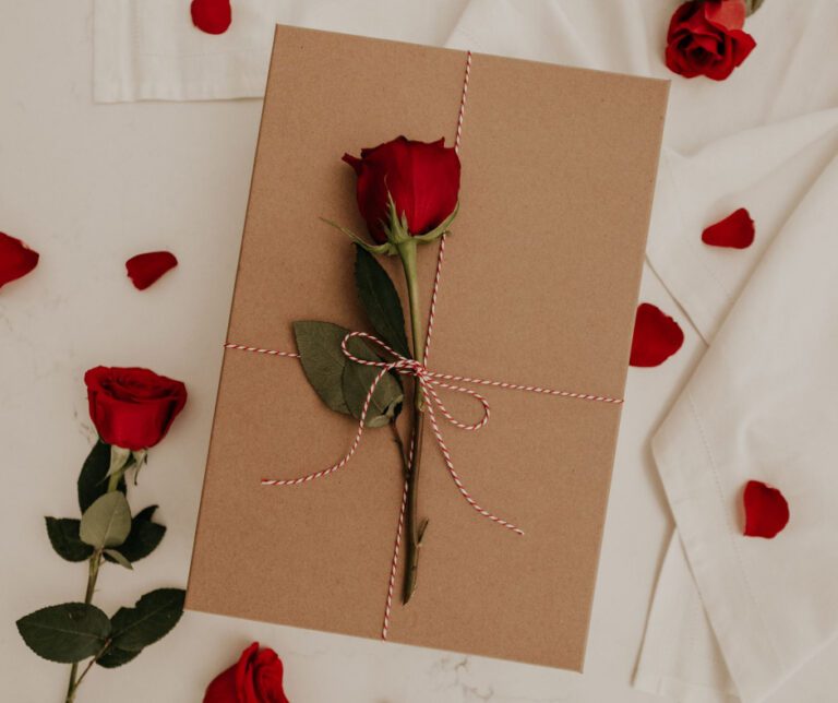 red rose, red hearts, and a Valentine's Day envelope